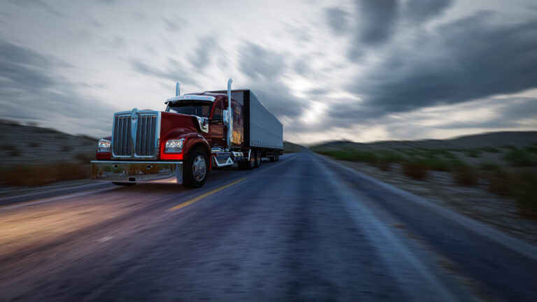 A shipping truck driving down a road