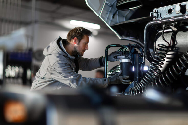 A man repairs a shipping truck