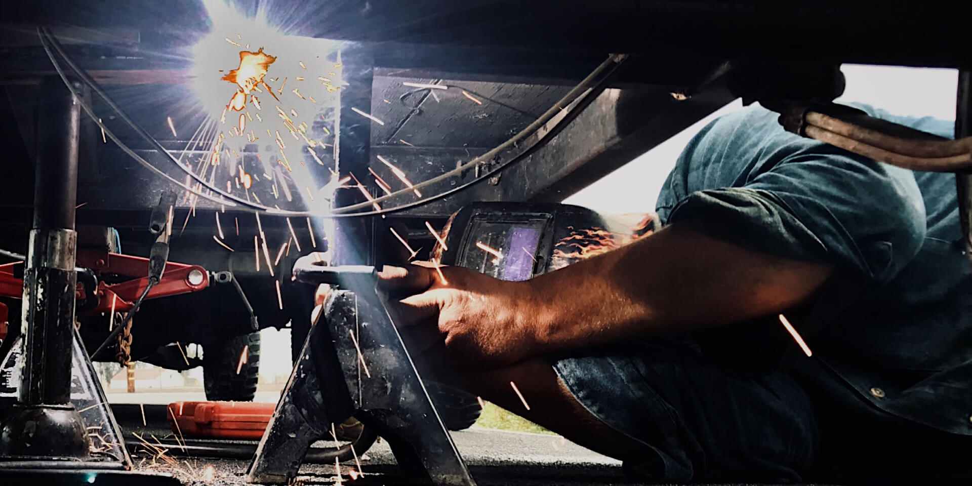 A man works on repairing a shipping truck