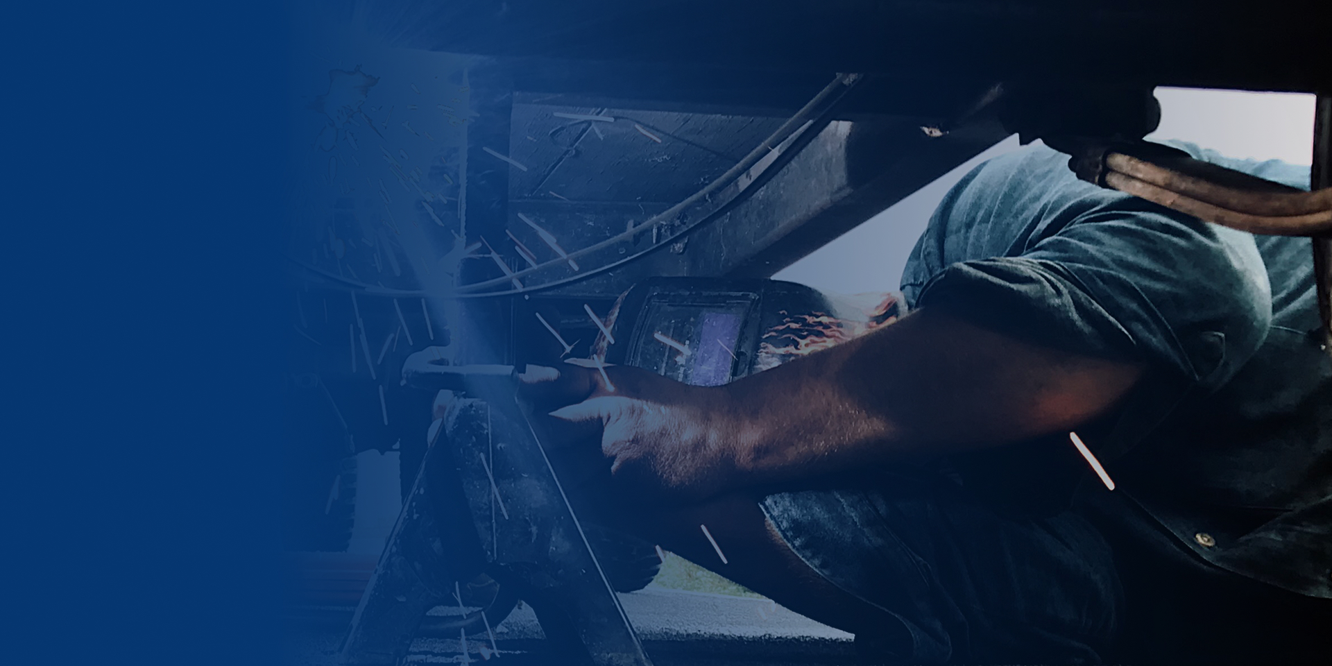 A man works on repairing a shipping truck